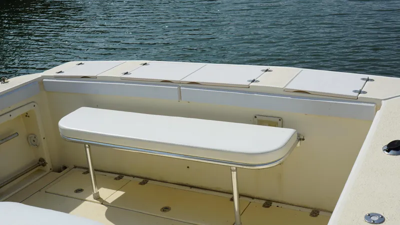Slide: The Image of 1996 Albin 28TE boat interior with white bench seating and storage compartments. - 7