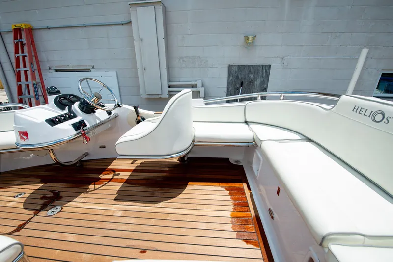 Slide: The Image of 2006 Novurania RHIB boat interior with white seating and wooden deck. - 14