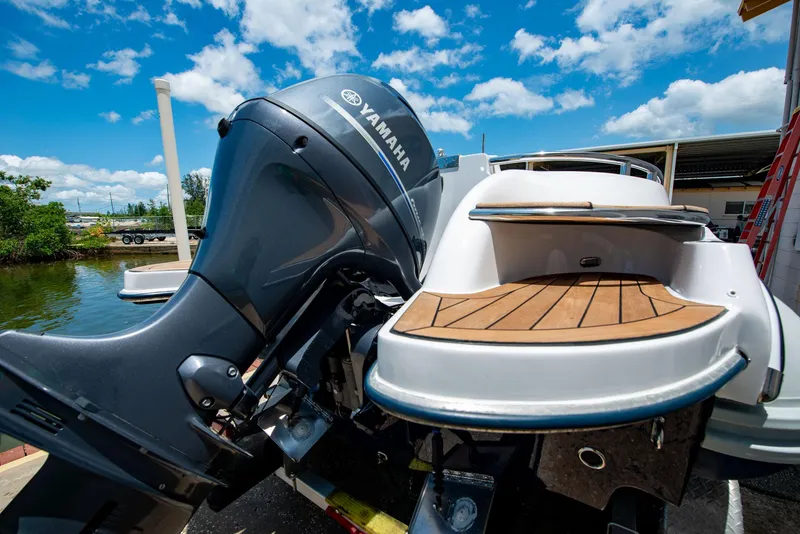 Slide: The Image of 2006 Novurania RHIB with Yamaha outboard motor, docked under a clear blue sky. - 18