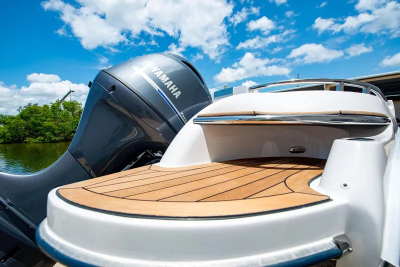 Slide: The Image of 2006 Novurania RHIB with Yamaha engine, featuring sleek wooden deck under a bright blue sky. - 19