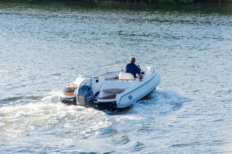 Slide: The Image of 2006 Novurania RHIB boat cruising on water with a single occupant. - 3
