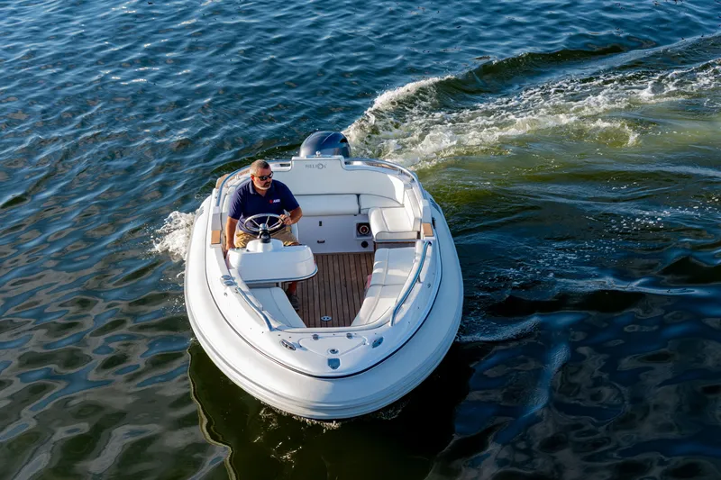 Slide: The Image of 2006 Novurania RHIB boat cruising on water with driver at helm. - 5