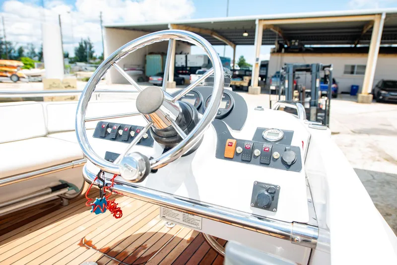 Slide: The Image of Steering wheel and controls of a 2006 Novurania RHIB boat, featuring a sleek design. - 7