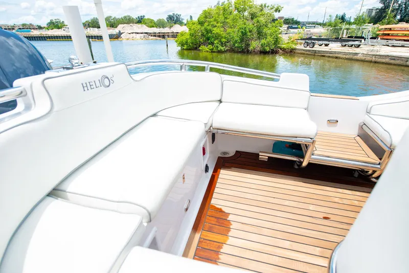 Slide: The Image of 2006 Novurania RHIB boat with white seating and wooden deck, docked by a scenic waterfront. - 9
