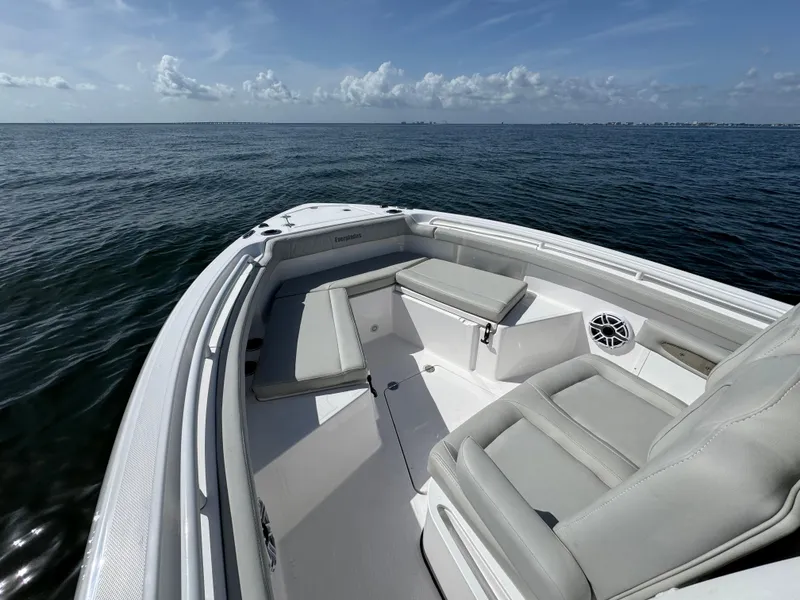 Slide: The Image of 2022 Everglades 235 Center Console boat on open water, featuring spacious seating. - 14