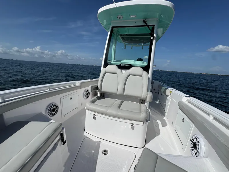 Slide: The Image of 2022 Everglades 235 Center Console boat on open water, featuring spacious seating and modern design. - 15