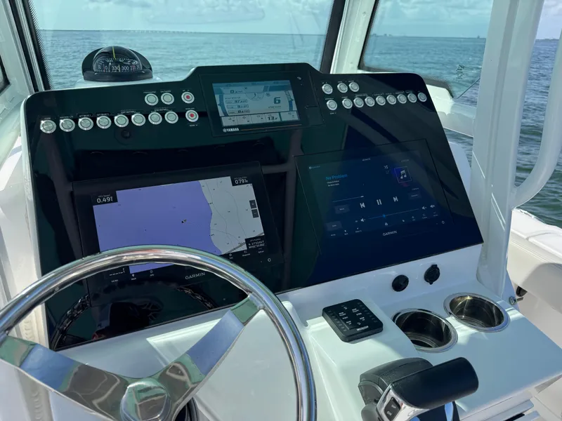 Slide: The Image of 2022 Everglades 235 Center Console boat dashboard with navigation and control systems. - 19