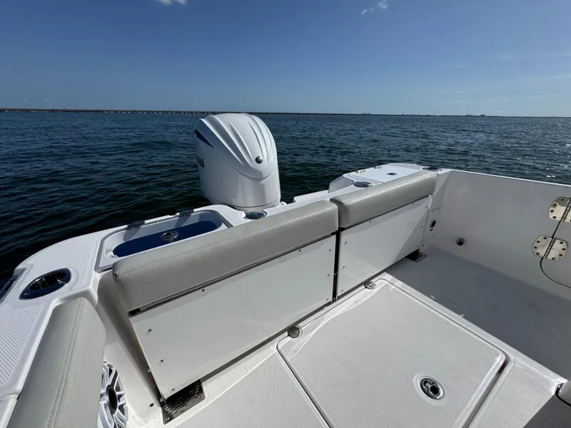 Slide: The Image of 2022 Everglades 235 Center Console boat on water, featuring sleek seating and powerful outboard motor. - 22