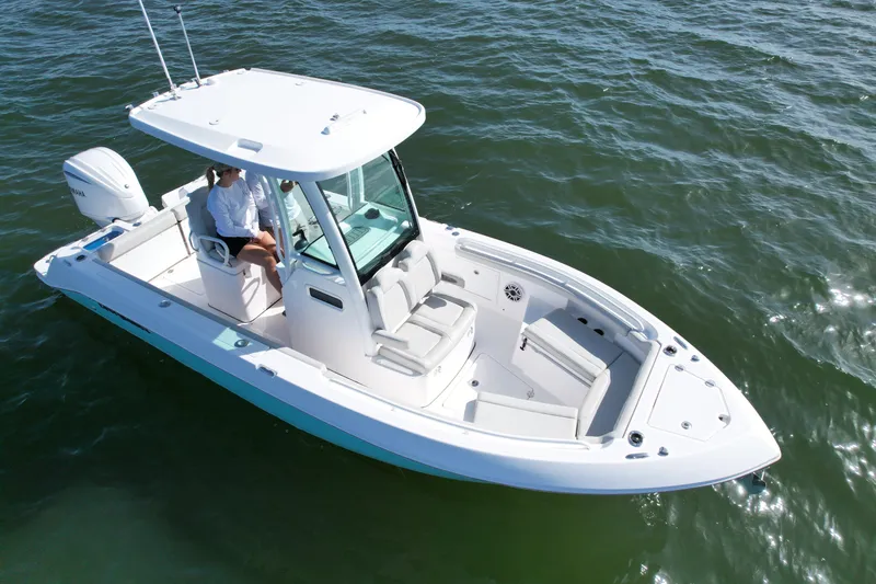 Slide: The Image of 2022 Everglades 235 Center Console boat on water, featuring sleek design and modern amenities. - 9