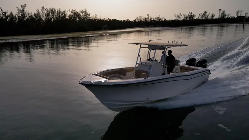 Slide: The Image of Grady-White 273 Chase CC 2025 boat cruising on calm water at sunset. - 1