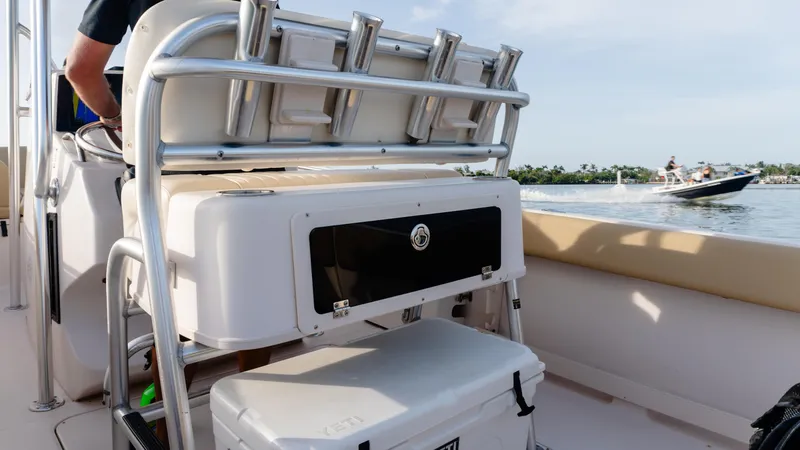 Slide: The Image of Grady-White 273 Chase CC boat interior with rod holders, cooler, and scenic water view. - 12