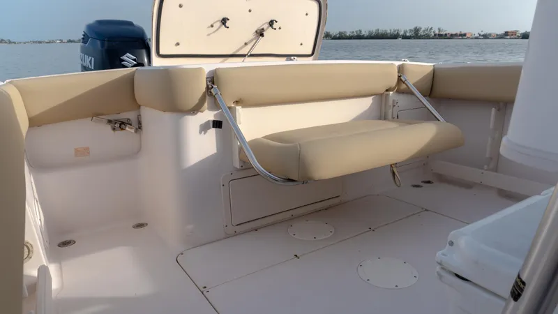 Slide: The Image of Grady-White 273 Chase CC 2025 boat interior with seating and Suzuki engine. - 16