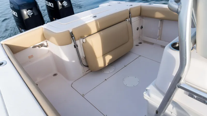 Slide: The Image of Grady-White 273 Chase CC 2025 boat interior with beige seating and Suzuki engines. - 18