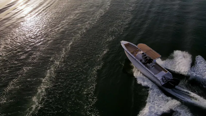 Slide: The Image of Aerial view of Grady-White 273 Chase CC boat cruising on open water at sunset. - 21
