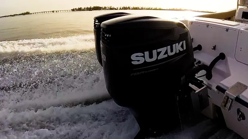 Slide: The Image of Grady-White 273 Chase CC boat with Suzuki outboard engines cruising on water. - 22