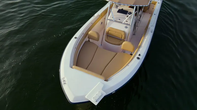 Slide: The Image of Grady-White 273 Chase CC 2025 boat on calm water, featuring spacious seating and sleek design. - 23