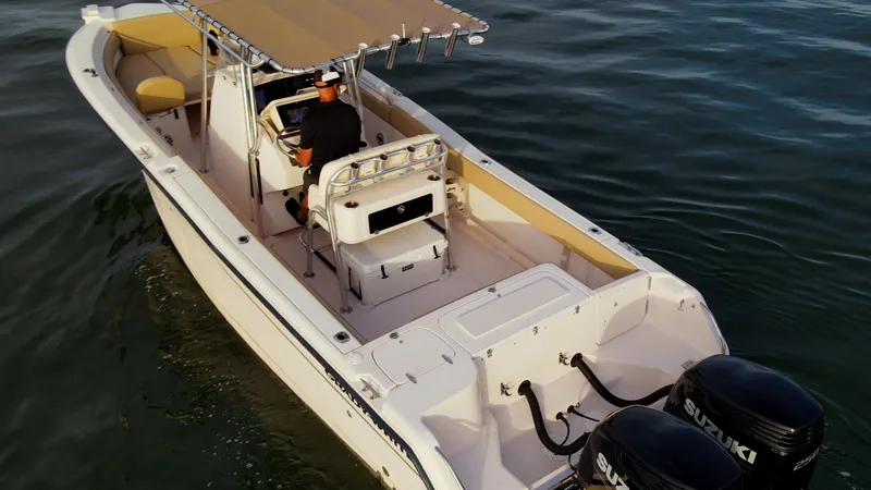 Slide: The Image of Grady-White 273 Chase CC boat on water, featuring dual Suzuki engines, 2025 model. - 24