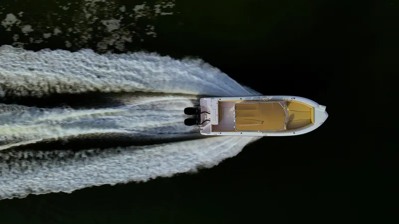 Slide: The Image of Aerial view of Grady-White 273 Chase CC boat speeding on water, 2025 model. - 25