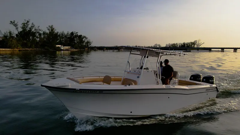 Slide: The Image of Grady-White 273 Chase CC boat cruising on calm water at sunset. - 27