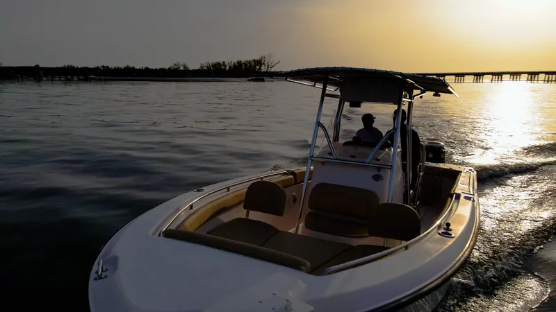 Slide: The Image of Grady-White 273 Chase CC boat cruising at sunset, 2025 model, serene water backdrop. - 28