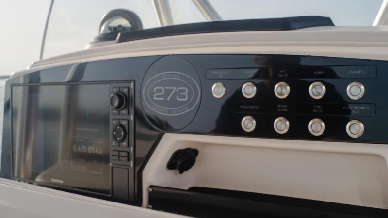 Slide: The Image of Control panel of Grady-White 273 Chase CC 2025 boat, featuring buttons and display. - 6