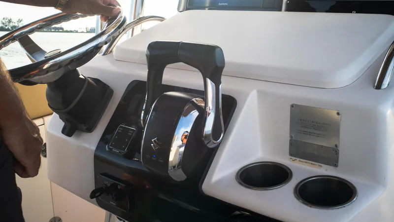 Slide: The Image of Control panel of Grady-White 273 Chase CC 2025 boat with steering wheel and throttle. - 7