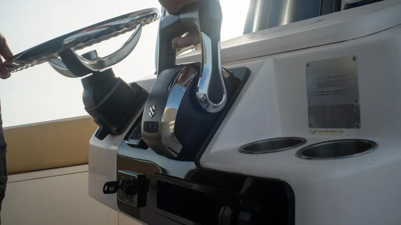 Slide: The Image of Steering console of Grady-White 273 Chase CC 2025 boat with controls and cup holders. - 8