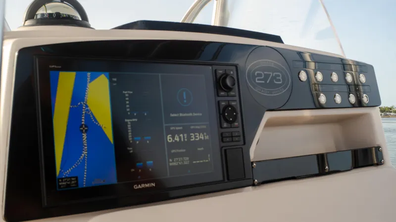 Slide: The Image of Grady-White 273 Chase CC 2025 boat dashboard with Garmin navigation system. - 9
