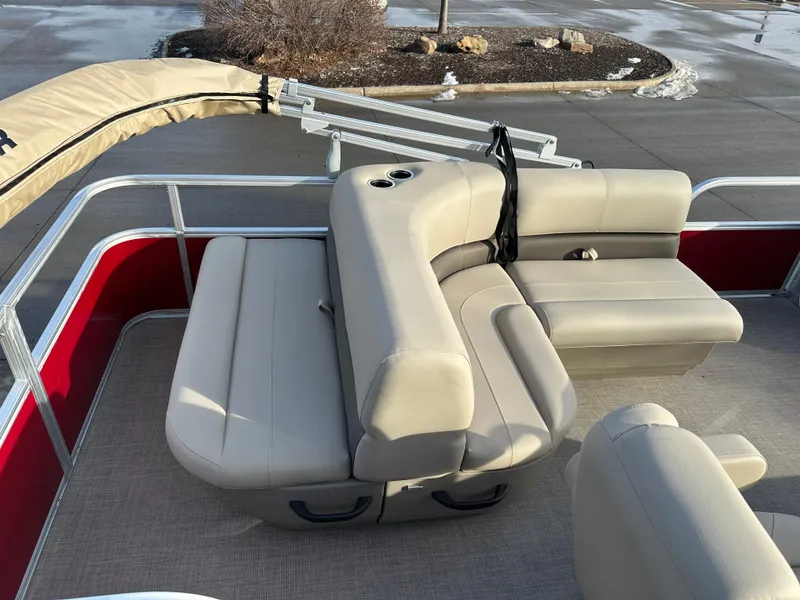 Slide: The Image of 2025 Sun Tracker Party Barge 18 DLX with beige seating and red accents on a pontoon boat. - 8