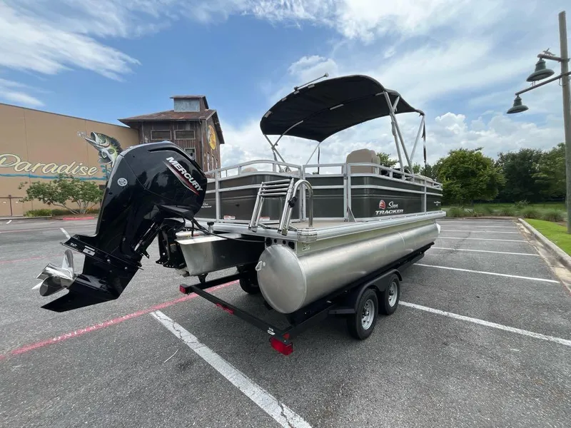 Slide: The Image of 2025 Sun Tracker Fishin' Barge 20 DLX pontoon boat with Mercury engine in parking lot. - 5