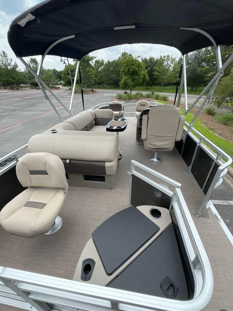Slide: The Image of 2025 Sun Tracker Fishin' Barge 20 DLX pontoon boat with spacious seating and canopy. - 6