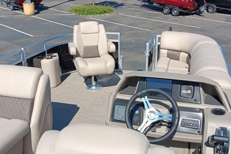 Slide: The Image of 2025 Sun Tracker SportFish 20 DLX pontoon boat interior with steering console and seating. - 3