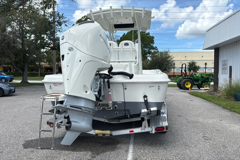 Slide: The Image of 2025 Ranger 2360 Bay boat with powerful outboard motor in parking lot. - 3