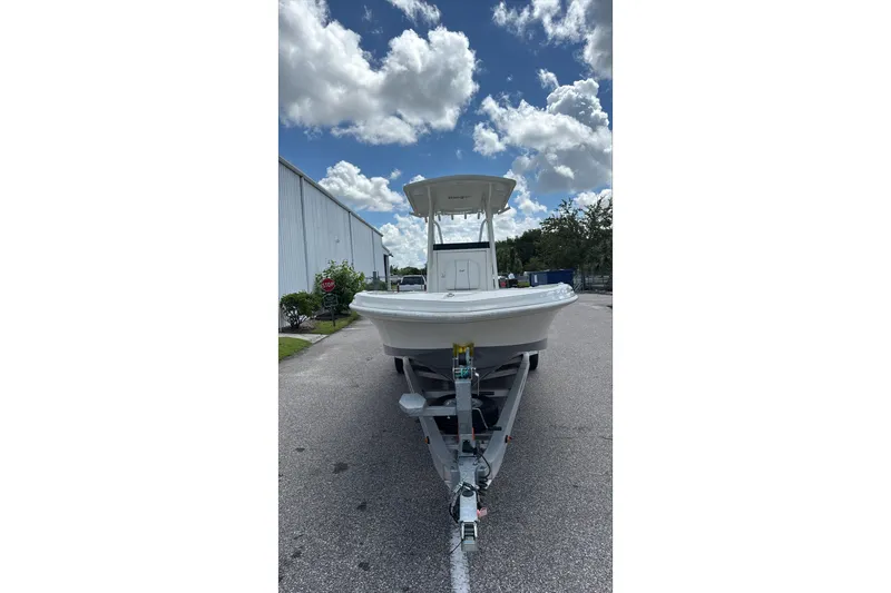 Slide: The Image of 2025 Ranger 2360 Bay boat on trailer under cloudy sky. - 16