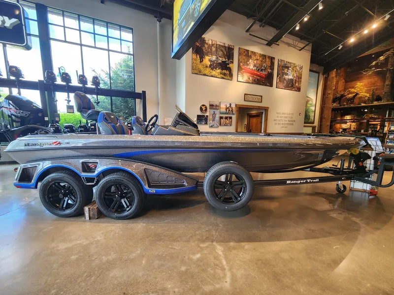 The Image of 2025 Ranger Z521R boat in a workshop, featuring a powerful outboard motor. - 0