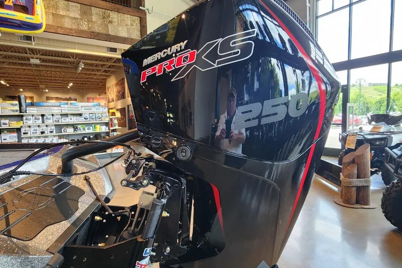 Slide: The Image of 2025 Ranger Z521R boat dashboard with Garmin displays and steering wheel. - 2