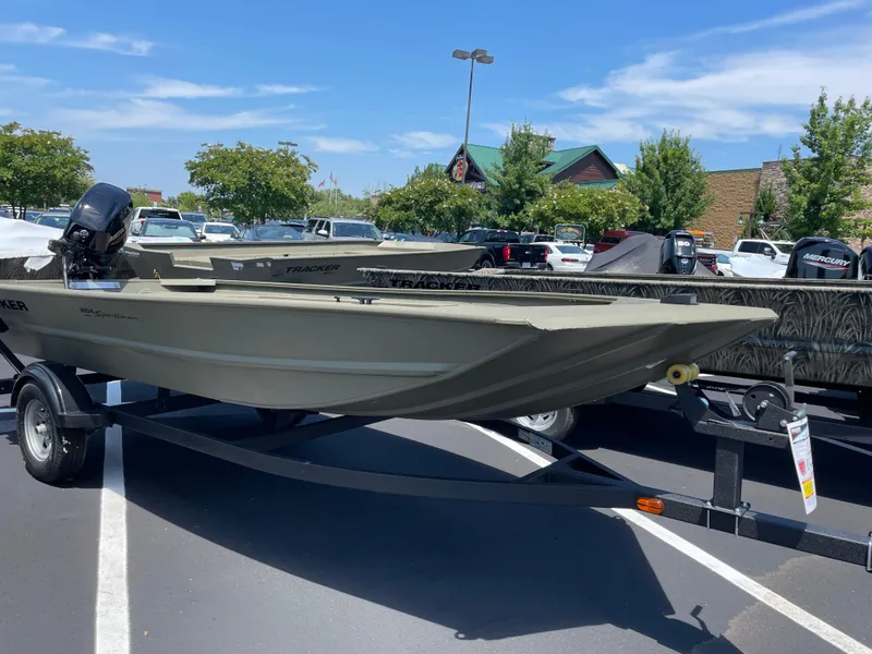 The Image of 2025 Tracker Grizzly 1654 T Sportsman boat on trailer in parking lot. - 0