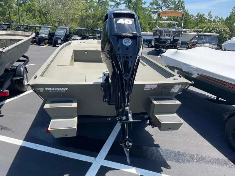 Slide: The Image of 2025 Tracker Grizzly 1654 T Sportsman boat with Mercury 40 engine in parking lot. - 3