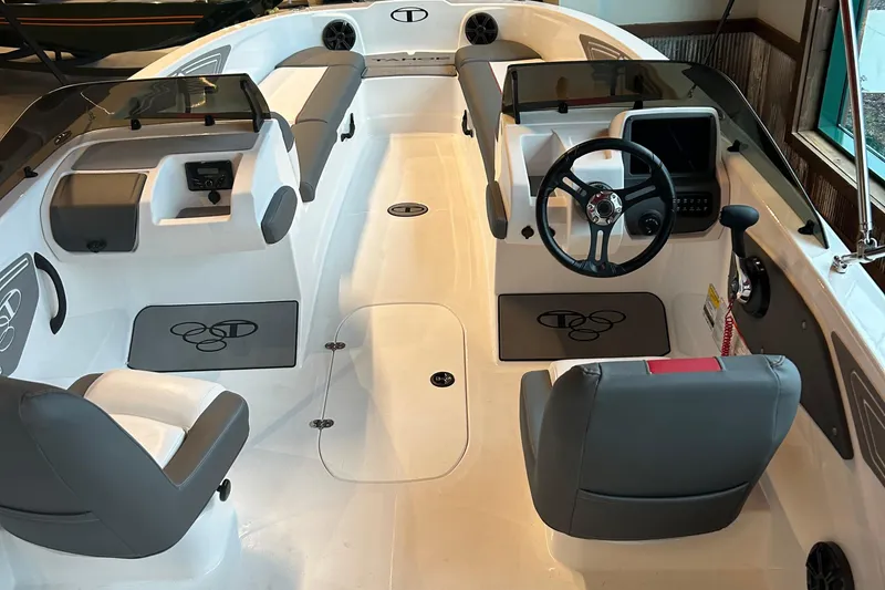 Slide: The Image of 2025 Tahoe T21 boat interior with modern seating and steering console. - 2