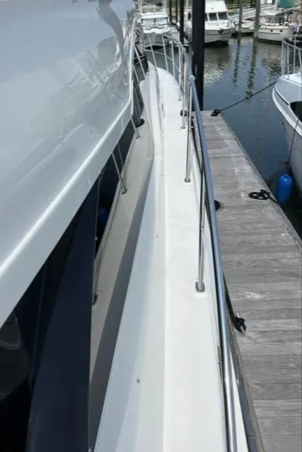 Slide: The Image of 2016 Sea Ray 510 Fly yacht docked at marina, side view. - 10