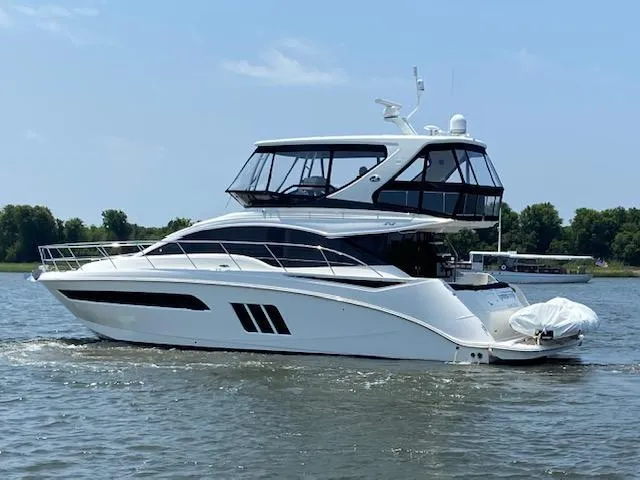 Slide: The Image of 2016 Sea Ray 510 Fly yacht cruising on a calm river. - 2
