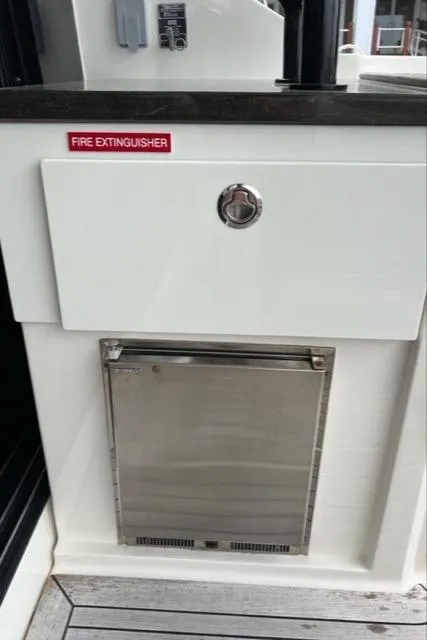 Slide: The Image of Fire extinguisher compartment on 2016 Sea Ray 510 Fly yacht deck. - 23