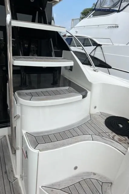 Slide: The Image of Staircase on 2016 Sea Ray 510 Fly yacht with wooden steps and sleek design. - 24