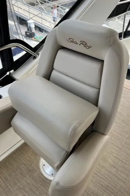 Slide: The Image of Captain's chair on 2016 Sea Ray 510 Fly yacht, featuring plush beige upholstery. - 27