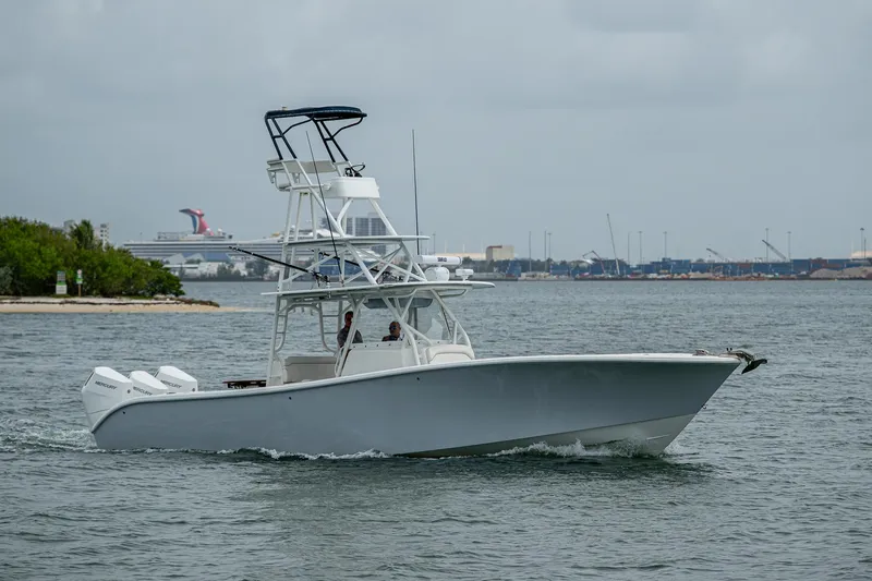The Image of 2013 Yellowfin 39 Offshore boat cruising on a calm sea near a coastal area. - 1