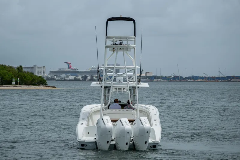 Slide: The Image of 2013 Yellowfin 39 Offshore boat with triple engines on the water, cruise ship in background. - 10