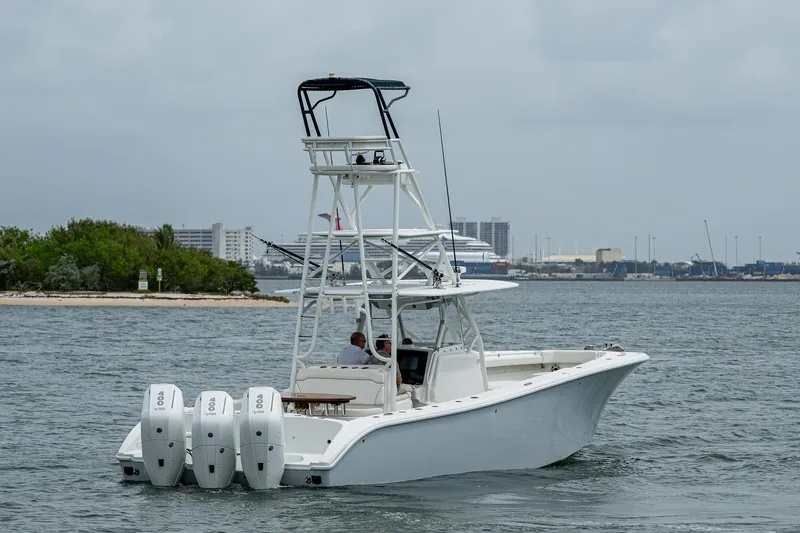 Slide: The Image of 2013 Yellowfin 39 Offshore boat with triple engines on the water. - 12