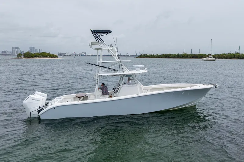 Slide: The Image of 2013 Yellowfin 39 Offshore boat on calm water, side view. - 14