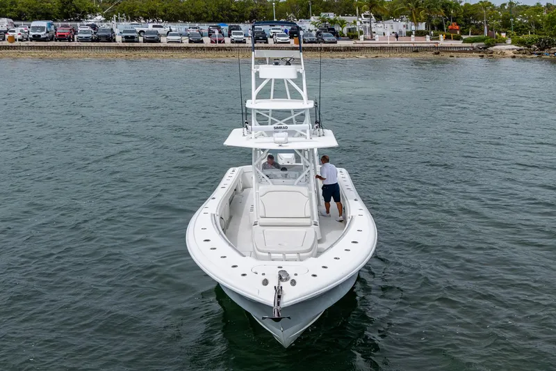 Slide: The Image of 2013 Yellowfin 39 Offshore boat on water, viewed from front. - 16