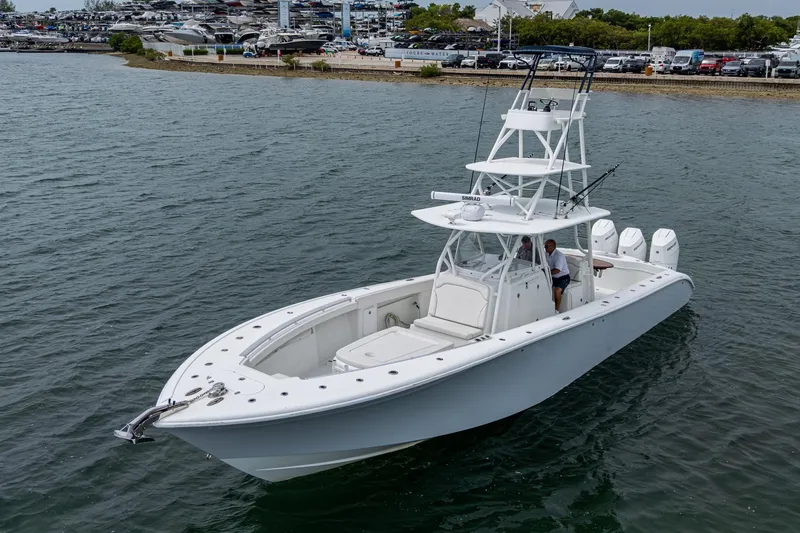 Slide: The Image of 2013 Yellowfin 39 Offshore boat on water, featuring sleek design and multiple engines. - 17